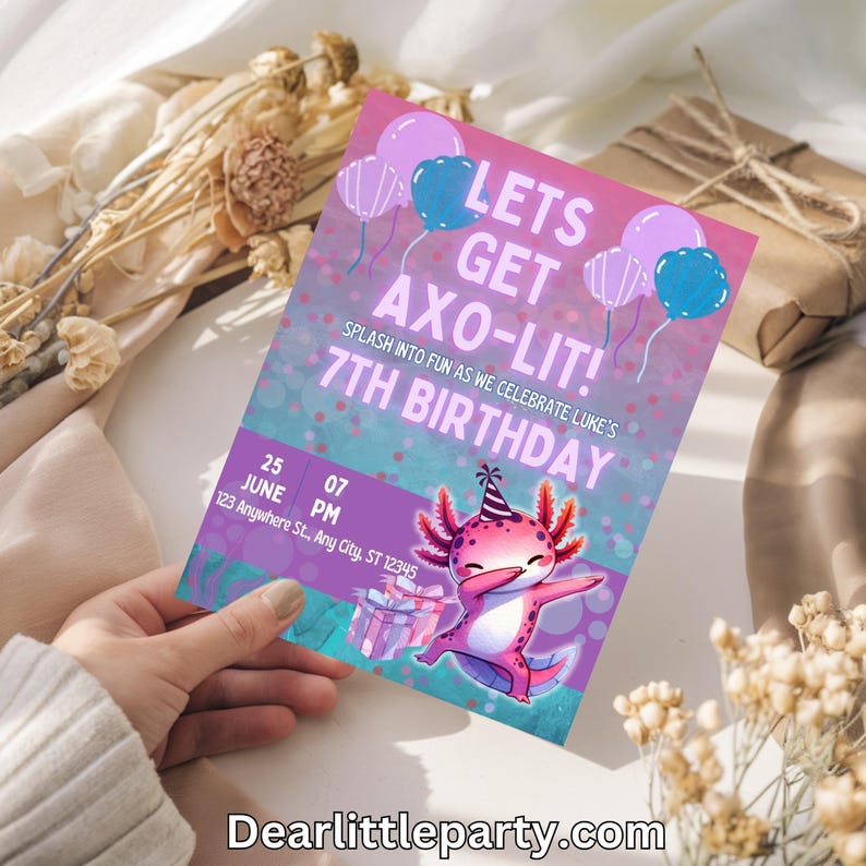 A hand holding a colorful birthday invitation featuring a pink and purple splash-themed design with a cute cartoon character.