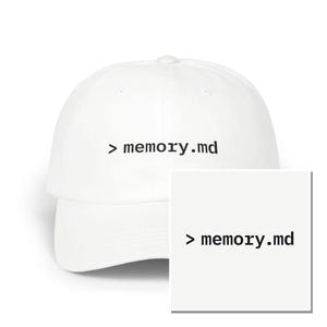 May include: A white baseball cap featuring the black text > memory.md embroidered on the front center. The cap has a structured crown, a curved brim, and a button at the top. A square inset shows the text > memory.md in a black sans-serif font.