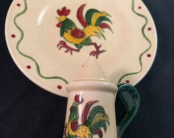 May include: A vintage salt and pepper shaker set with a rooster design. The shakers are white with green and red accents. The rooster is yellow with green and red feathers.