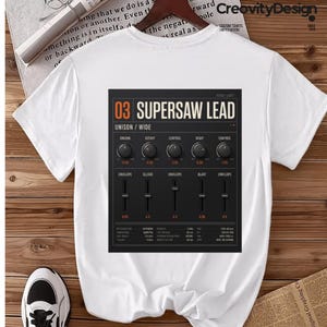 May include: A white short-sleeved t-shirt featuring a large rectangular graphic on the back. The graphic displays a black synthesizer control panel interface with the text 03 SUPERSAW LEAD, various knobs, sliders, and technical parameter labels.