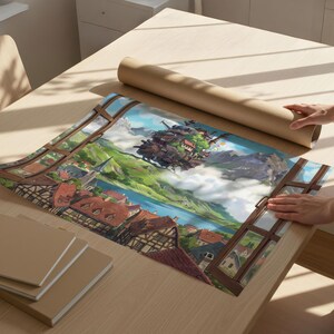 May include: A rolled poster depicting a fantasy landscape with a town, mountains, and a lake. The poster is on a wooden table with a stack of notebooks. The scene is viewed through a window frame.