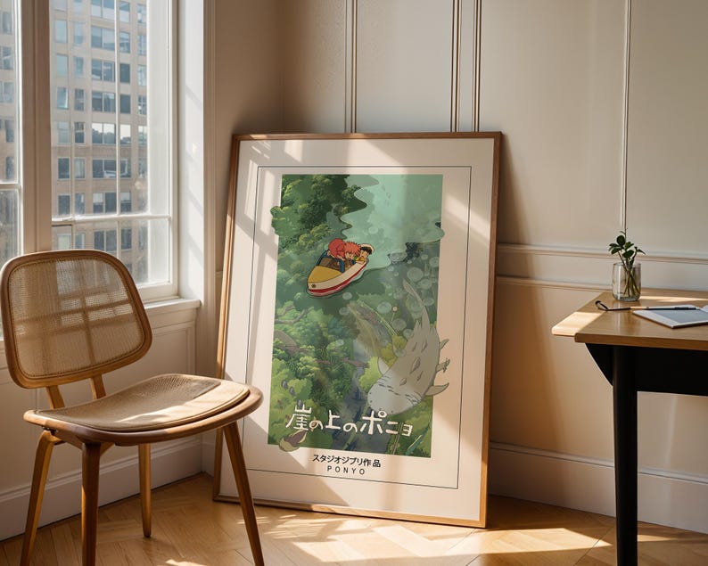 May include: Framed poster of the animated film "Ponyo." The image shows a boat with two characters on the water, and a large fish-like creature beneath. The poster is in a wooden frame, leaning against a wall near a window, next to a wooden chair.