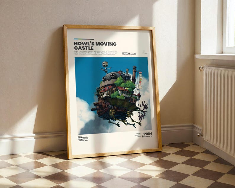 May include: Framed poster featuring the animated film "Howl's Moving Castle." The artwork depicts the castle floating in a blue sky with clouds. The poster includes the film's title and the year 2004.