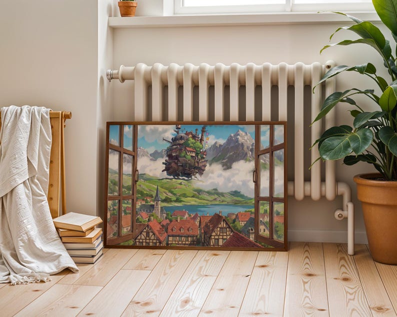May include: A framed artwork showing a fantasy landscape through an open window. It features a floating castle, a village with red-tiled roofs, mountains, and a lake. The artwork is on a wooden floor, next to a plant in a terracotta pot.