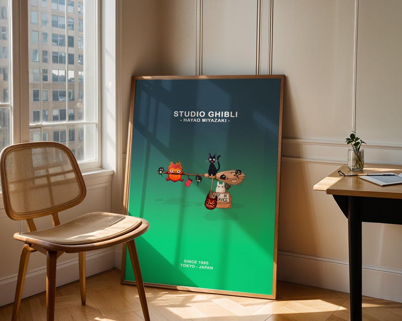 May include: A framed poster featuring a Studio Ghibli design with a green and blue gradient background. The poster includes illustrations of animated characters and the text "STUDIO GHIBLI - HAYAO MIYAZAKI" and "SINCE 1985 TOKYO - JAPAN."