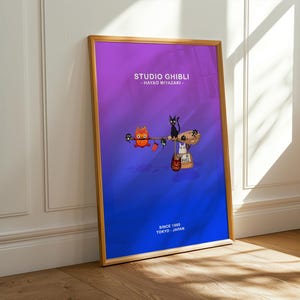 May include: A framed poster featuring Studio Ghibli characters against a gradient purple and blue background. The poster includes the text "STUDIO GHIBLI - HAYAO MIYAZAKI" and "SINCE 1985 TOKYO JAPAN". The artwork depicts animated characters.