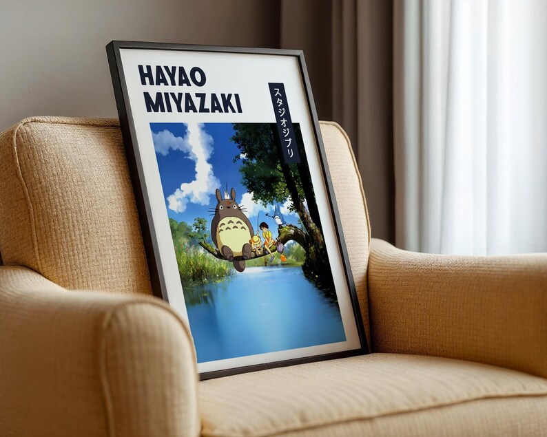 May include: Framed art print featuring a scene from a Hayao Miyazaki film. The artwork depicts a large, furry creature and several children on a tree branch over a body of water. The print has the text "HAYAO MIYAZAKI" and Japanese text.