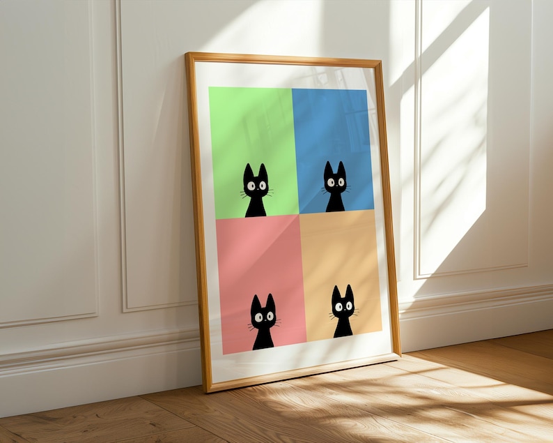 May include: A framed art print featuring four panels, each with a different pastel background color: green, blue, pink, and orange. Each panel displays a black cat silhouette with large eyes. The frame is made of wood.
