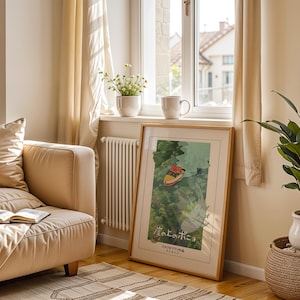 May include: A framed art print with a boat illustration and Japanese text, displayed in a room with a beige sofa, a potted plant, and a window with sheer curtains. The wooden frame surrounds the colorful artwork. The room has a cozy, natural feel.