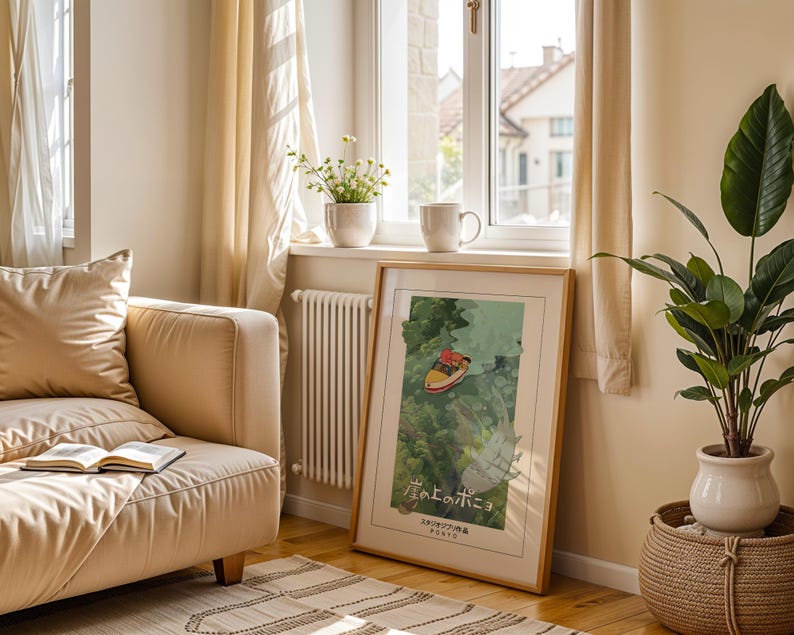 May include: A framed art print with a boat illustration and Japanese text, displayed in a room with a beige sofa, a potted plant, and a window with sheer curtains. The wooden frame surrounds the colorful artwork. The room has a cozy, natural feel.