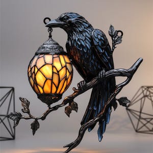 May include: A black raven wall sconce with a stained glass lamp. The raven is perched on a branch with leaves, holding a round, amber-colored lamp. The lamp has a decorative metal cap and a chain.