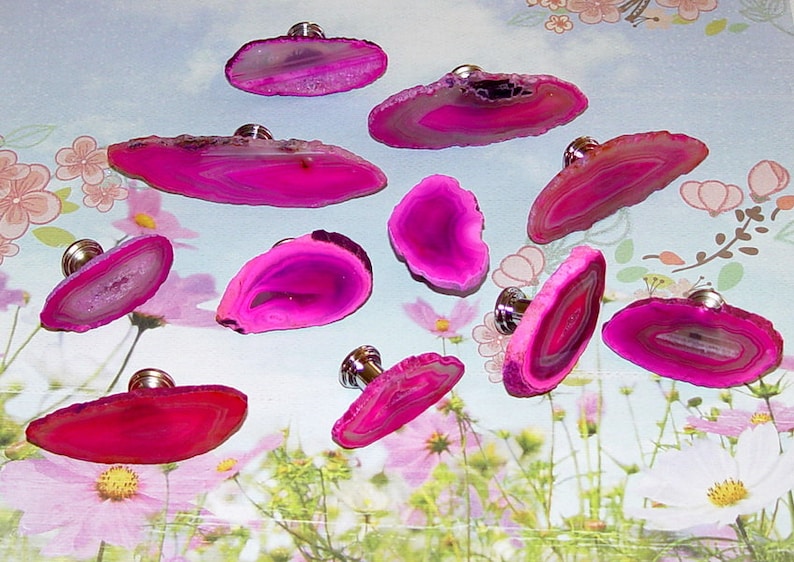 May include: Ten pink agate drawer pulls with silver knobs. The agate is translucent and has white and pink layers.