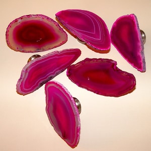May include: Six pink agate slices with silver metal knobs, perfect for use as cabinet knobs or drawer pulls.
