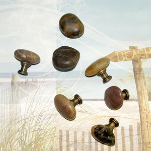 May include: Six natural stone cabinet knobs with brass hardware. The knobs are various shades of brown, tan, and gray.