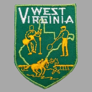May include: A green embroidered patch with the words "West Virginia" in white lettering. The patch features a yellow outline of the state of West Virginia with three yellow figures inside. The figures depict a person playing a musical instrument, a person holding a pickaxe, and a person riding a horse.