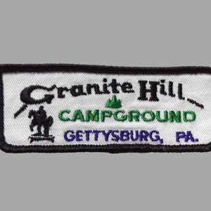 May include: Embroidered patch with the words "Granite Hill Campground Gettysburg, PA." The patch is rectangular with a white background and a black border. The text is in black, green, and blue.