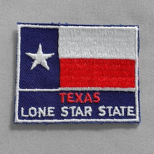 May include: A blue and red embroidered patch with a white star and the words "TEXAS LONE STAR STATE".