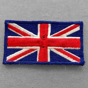 May include: A blue, red, and white embroidered patch of the Union Jack flag.