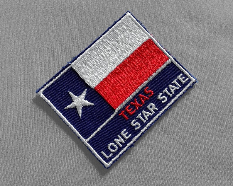May include: A blue and red embroidered patch with a white star and the text "TEXAS LONE STAR STATE".