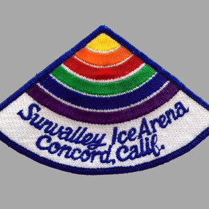 May include: A white, blue, and rainbow embroidered patch with the text "Sunvalley Ice Arena Concord, Calif."