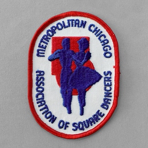 May include: Embroidered patch with a red border and the text "Metropolitan Chicago Association of Square Dancers." The patch features a red background with two blue dancing figures.
