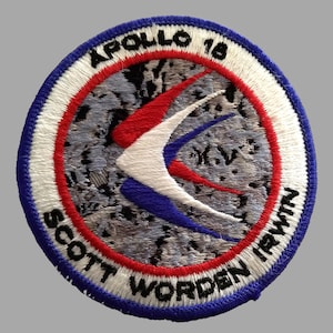May include: Embroidered Apollo 16 mission patch. The circular patch features a red, white, and blue design with the mission name and crew names. The patch has a blue border with white text that reads "APOLLO 16" and "SCOTT WORDEN IRWIN".