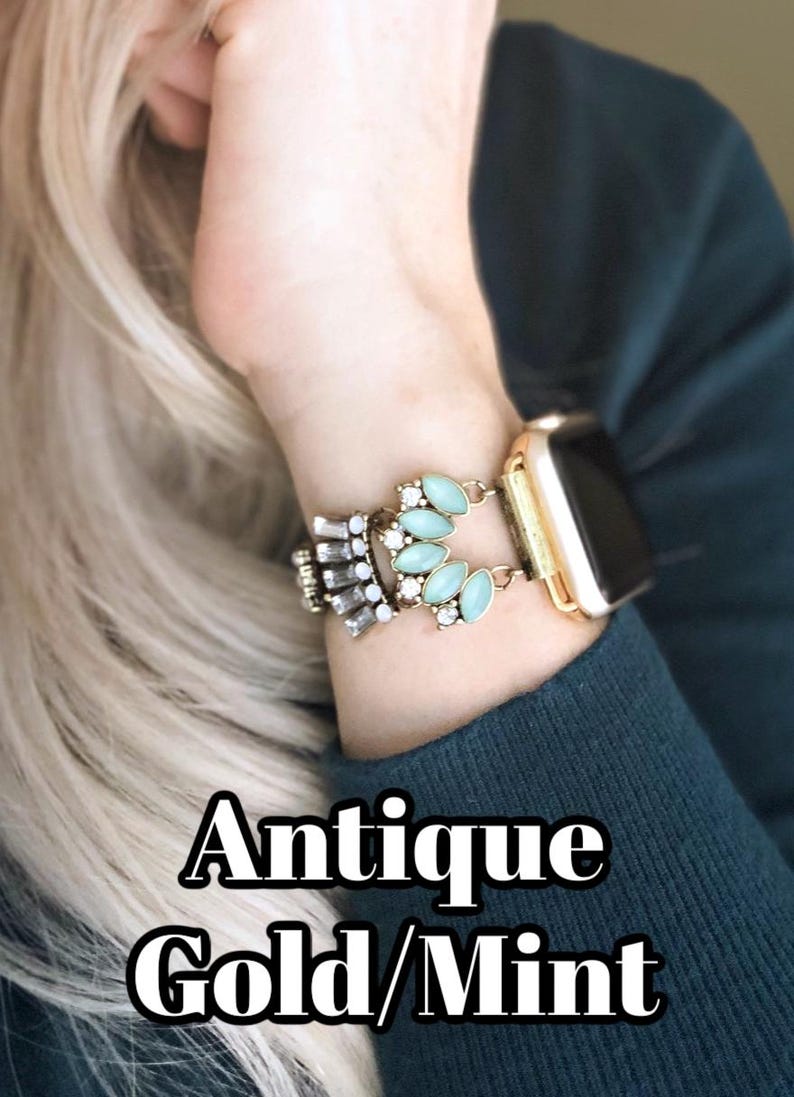May include: A gold and mint green watch band with a decorative design featuring rhinestones and oval-shaped stones.  Antique Gold/Mint