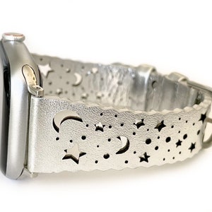 May include: Silver smartwatch band with a moon and stars cut-out design.
