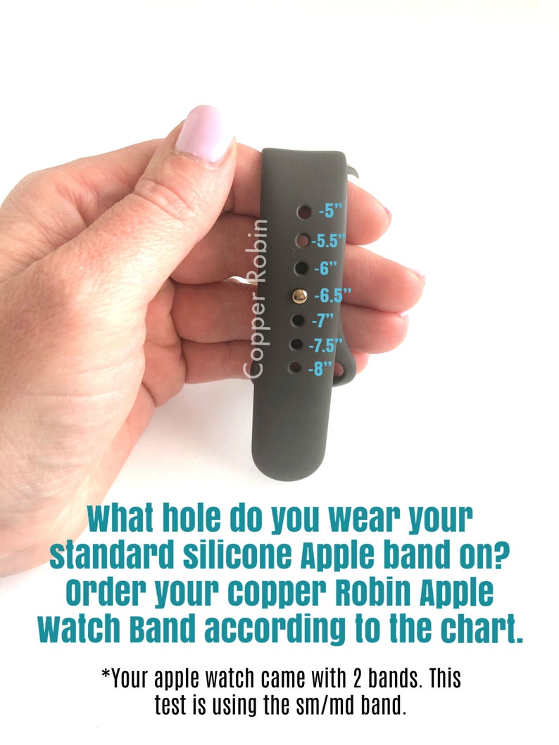 May include: A gray silicone Apple Watch band with a size chart printed on the side. The chart shows sizes from 5 to 8 inches. The text "Copper Robin" is printed vertically on the band.