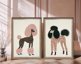 May include: Two framed art prints featuring stylized poodles. One poodle has a pink head and leg accents with a leopard print body. The other has a black head and leg accents with a red and white spotted body.