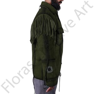 Side profile of a olive green suede leather western shirt jacket for men, showcasing long shoulder fringes, tribal-style patchwork on the sleeve, and lace-up detailing along the seams. This cowboy-inspired jacket is ideal for festivals, casual wear, and western cosplay. Handmade with real suede and attention to vintage fashion details