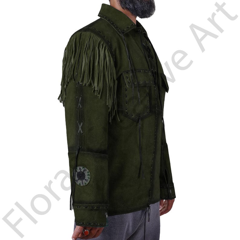 Side profile of a olive green suede leather western shirt jacket for men, showcasing long shoulder fringes, tribal-style patchwork on the sleeve, and lace-up detailing along the seams. This cowboy-inspired jacket is ideal for festivals, casual wear, and western cosplay. Handmade with real suede and attention to vintage fashion details