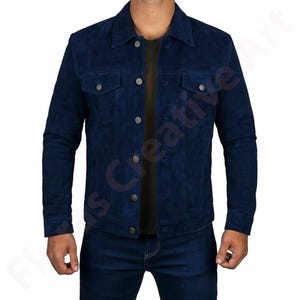 May include: A navy blue suede jacket with a button-up front, two chest pockets, and a collared neckline. The jacket is paired with matching blue jeans. The jacket has silver buttons.