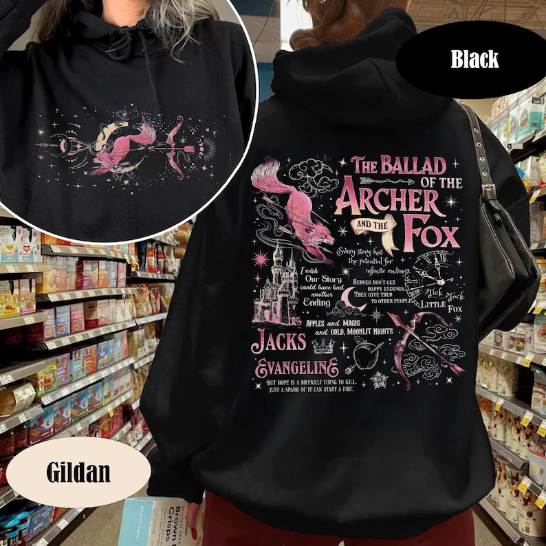 May include: Black hooded sweatshirt with a pink and white graphic on the back featuring a fox, bow and arrow, and text that reads "The Ballad of the Archer and the Fox." The Gildan brand logo is visible.