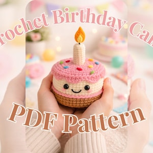 May include: A crocheted birthday cake with a candle, held in hands. The cake is pink, white, and brown, with colourful sprinkles and a smiling face. Text on the image reads "Crochet Birthday Cake PDF Pattern."