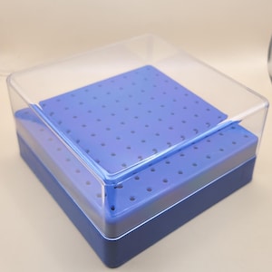 May include: A blue plastic storage box with a clear lid. The box has a perforated top and a solid base. The lid is transparent, allowing visibility of the contents. The box is designed for organizing and storing small items.