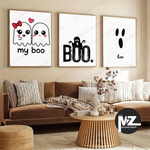 May include: Three framed Halloween-themed wall art prints. The first features two cartoon ghosts with the text "my boo." The second says "BOO." with a ghost silhouette. The third says "boo." in a minimalist style.