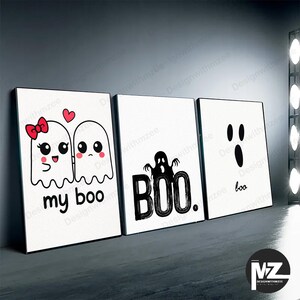 May include: Three framed Halloween-themed art prints. The first features two cartoon ghosts with the text "my boo." The second print says "BOO" with a ghost illustration. The third print says "boo" with a ghost face.