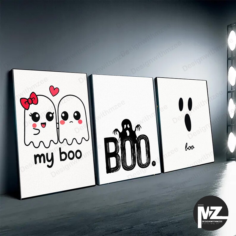 May include: Three framed Halloween-themed art prints. The first features two cartoon ghosts with the text "my boo." The second print says "BOO" with a ghost illustration. The third print says "boo" with a ghost face.