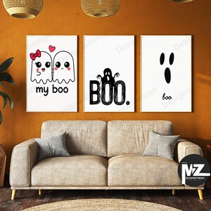 May include: Three framed Halloween-themed art prints. The left print features two cartoon ghosts with the text "my boo." The center print has a ghost and the word "BOO." The right print shows a ghost face and the word "boo."