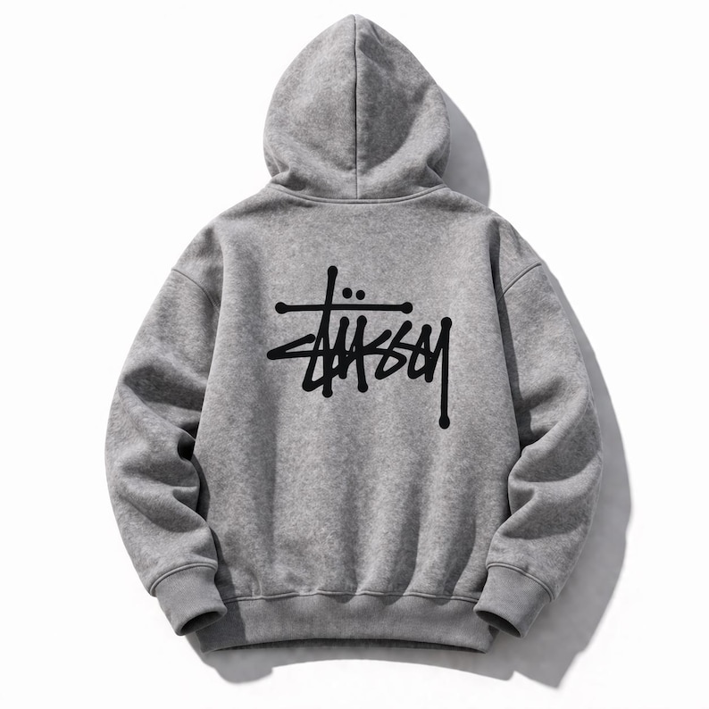 May include: A gray hoodie with a drawstring hood and a large black logo on the back. The logo is a stylized wordmark. The hoodie is made of a soft, comfortable material, perfect for casual wear. The hoodie is a classic streetwear staple.