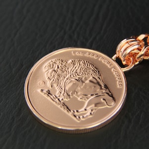 Close-up of the reverse side of the pendant - an image of a Buffalo and 1oz. 999 PURE COPPER embossed on it.