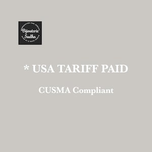 May include: A pale grey background with white text reading "* USA TARIFF PAID" and "CUSMA Compliant". A black square with white text that reads "Bijouterie Sudha" is in the upper left corner.