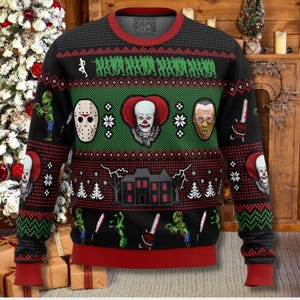 May include: Black, red, and green holiday sweater featuring horror movie characters and imagery. The design includes images of a haunted house, zombies, and iconic villains. The sweater has a crew neck and ribbed cuffs and hem.