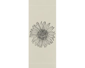 May include: A beige yoga mat with a black line drawing of a sunflower in the center.