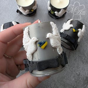 May include: A set of three ceramic mugs with a speckled, matte finish. The mugs are in shades of cream, light gray, and dark gray. Each mug has a simple, minimalist design, perfect for coffee or tea.