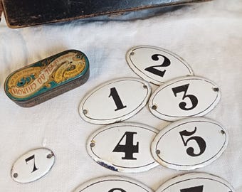 An antique numbered enamel plaque, an old French enamel number, a vintage oval enamel plaque, a vintage French enamel sign plaque