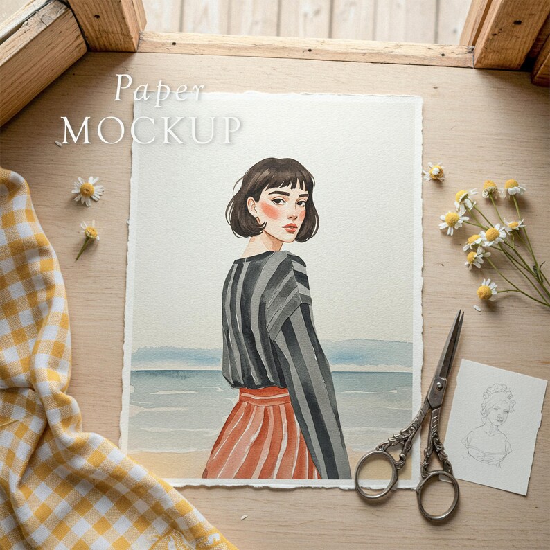 May include: Watercolor painting of a woman in a striped top and red skirt, standing near the ocean. The artwork is on textured paper, with the words "Paper MOCKUP" in the upper left corner. A pair of scissors and daisies are on the wooden surface.