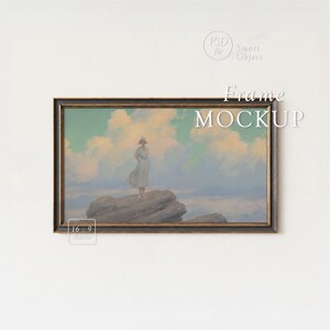 May include: A framed art print mockup featuring a vintage painting of a person standing on a rock, with a cloudy sky backdrop. The frame is dark with gold trim. The text "Frame MOCKUP" is displayed on the image.