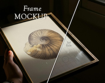 May include: A framed art print mockup with a vintage aesthetic. The frame is a dark metallic color, and the artwork features a detailed illustration of a nautilus shell in shades of brown and beige. The text "Frame MOCKUP" is visible at the top.